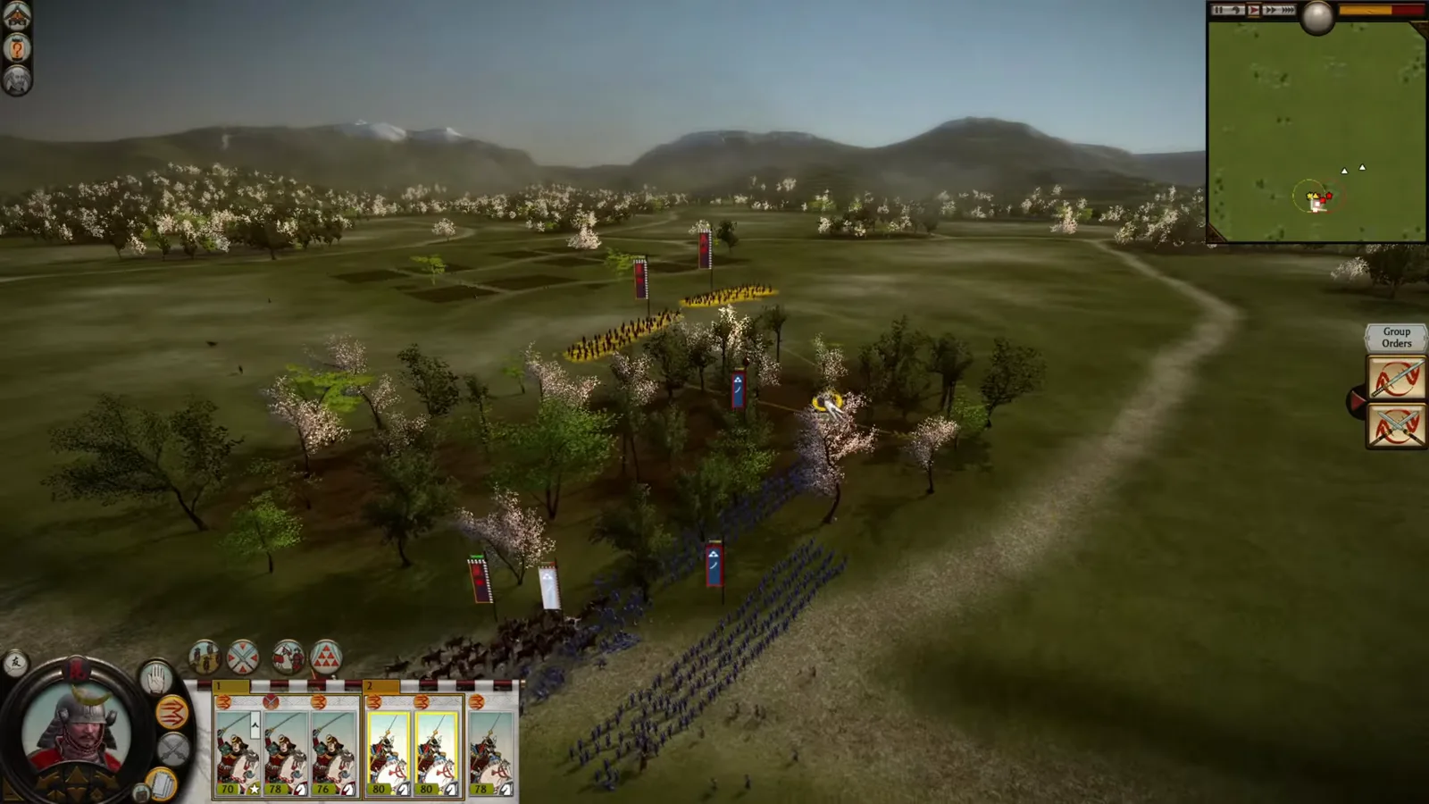 Classic Shogun 2 cavalry and infantry engage from different directions beside woodland in a hammer-and-anvil demonstration.