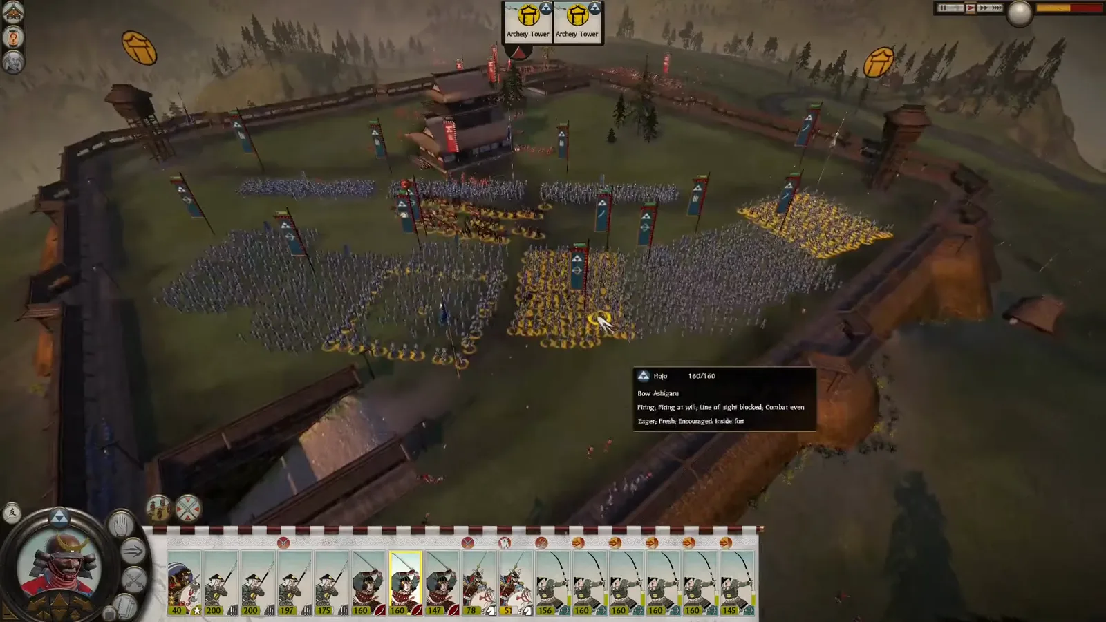 Shogun 2 formations fight inside a small castle courtyard with selected defenders near the side of the melee.